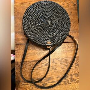 Black Woven Round Crossbody Bag, bright interior. Accents of contrasting tan. 8”